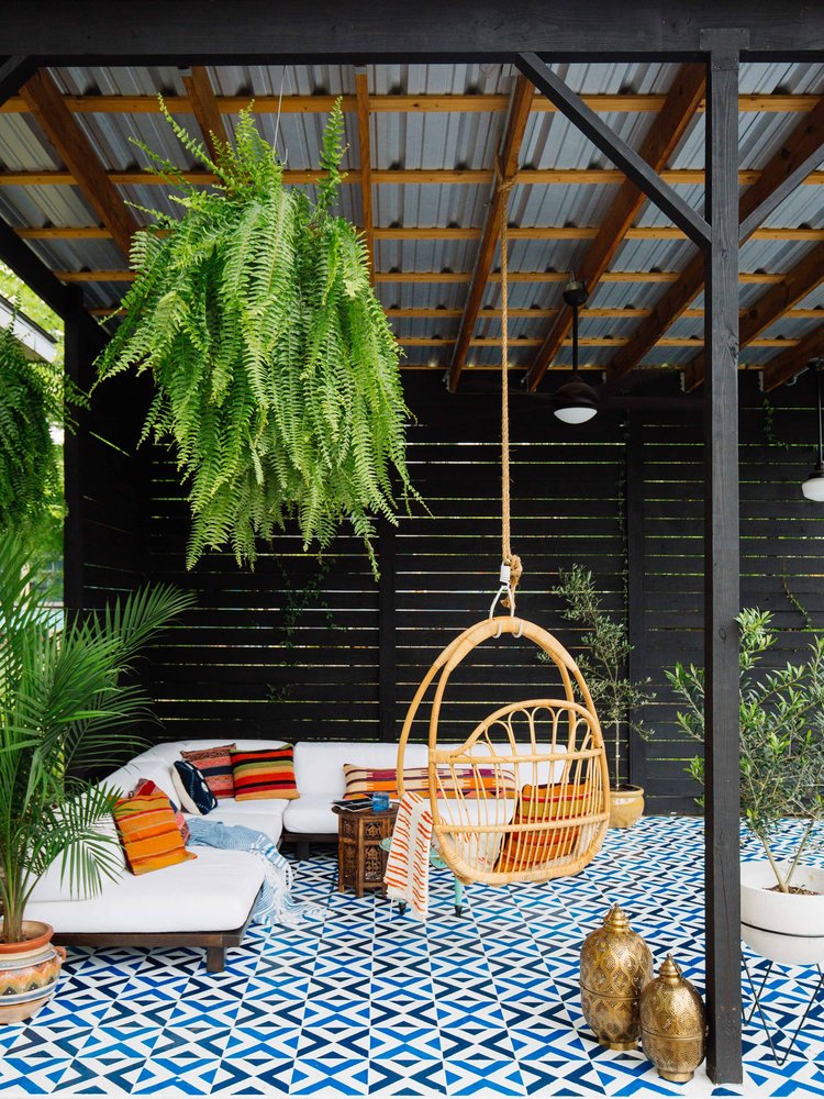 private boho patio with wicker swing seat