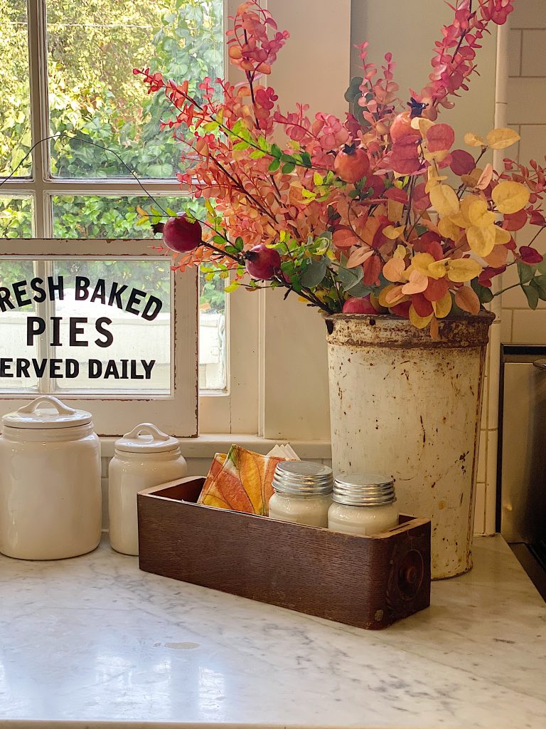 Fall kitchen decor with flowered in rustic can on countertop