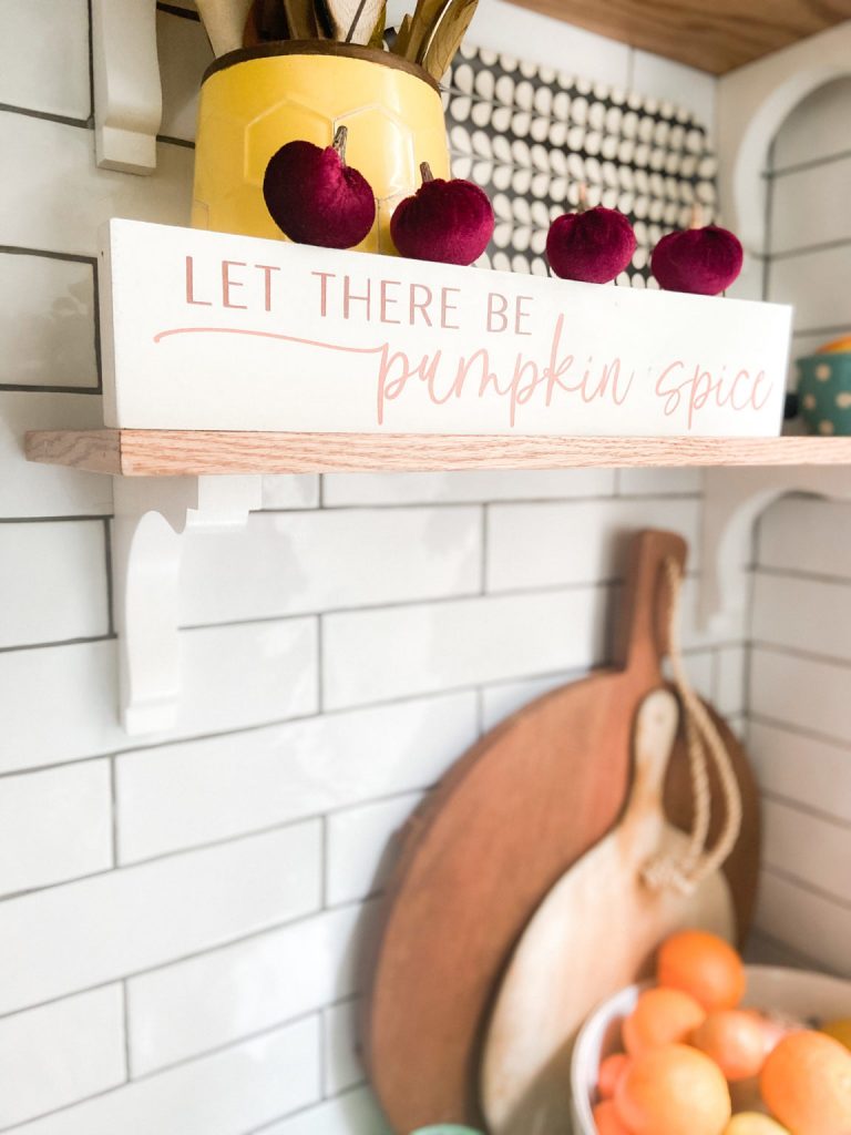 Fall kitchen shelf signage with wooden cutting boards