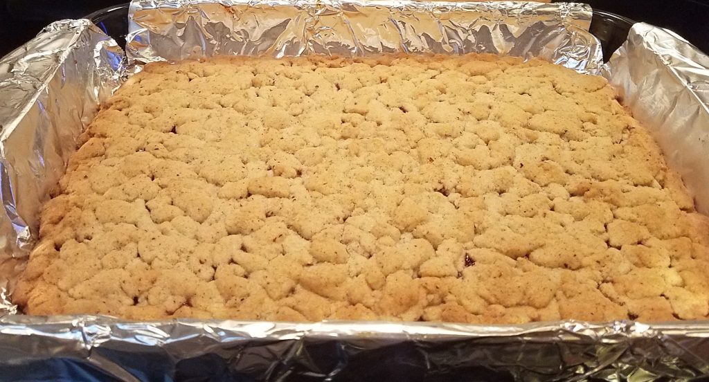 raspberry bars backed in a foil lined dish