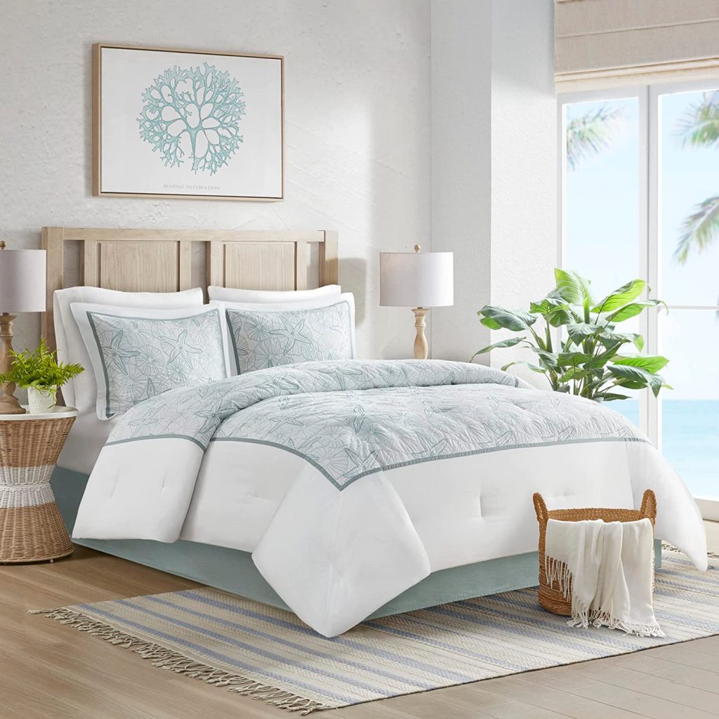 pale blue and white coastal bedroom with wicker decor