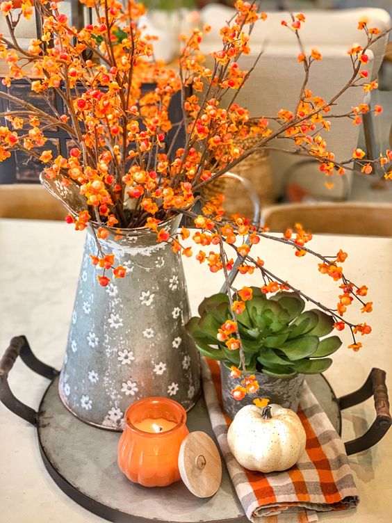 Farmhouse pitcher of flowers on tray with pumpkin for early fall