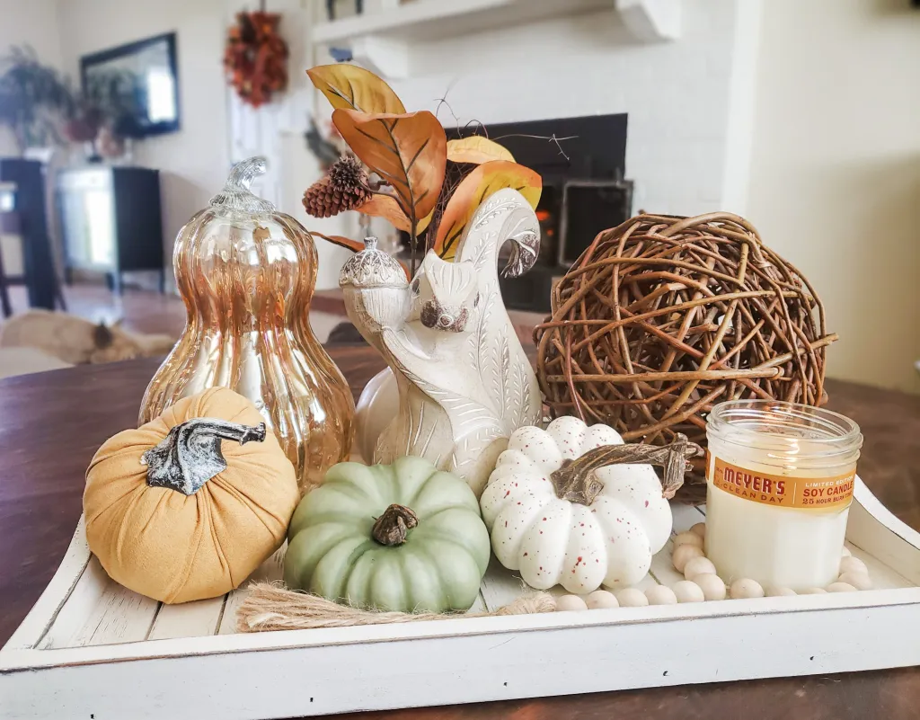 fall tray vignette with glass pumpkin, orb, pumpkins and wooden squirrel